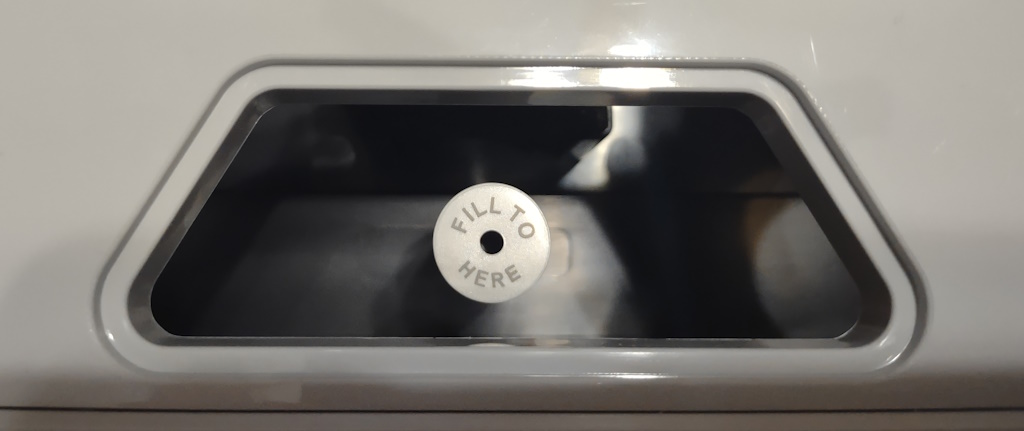 View of the water level sensor inside an AeroGarden Harvest as seen through the water fill access point in the tray