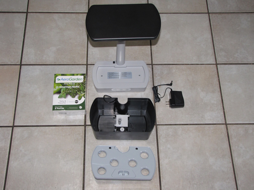 AeroGarden Harvest broken down to base, tub, tray, power supply, and box of pods