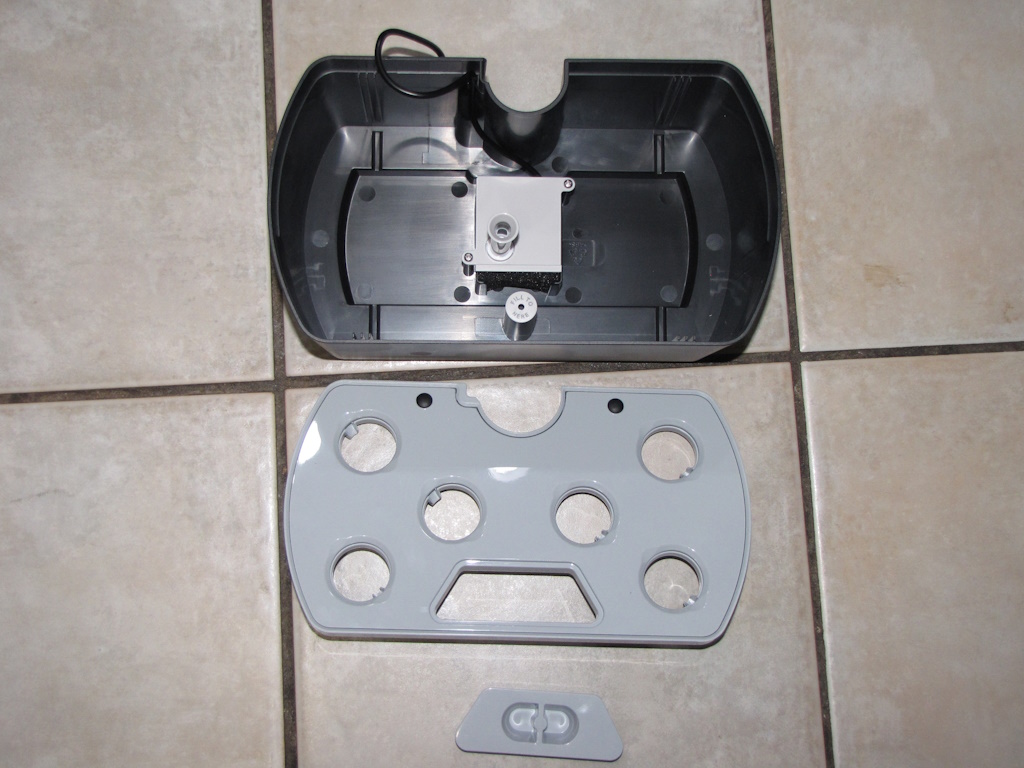 AeroGarden Harvest tub, tray, and water cap arranged in series on tile floor