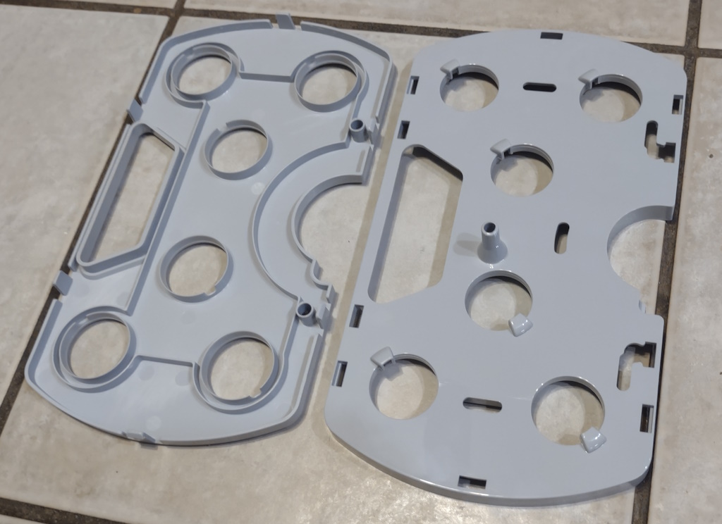 AeroGarden Harvest growing tray disassembled and laying in two parts on tile floor