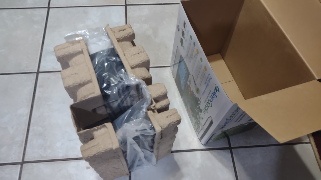 Contents of the AeroGarden Harvest box removed, with the empty box shown