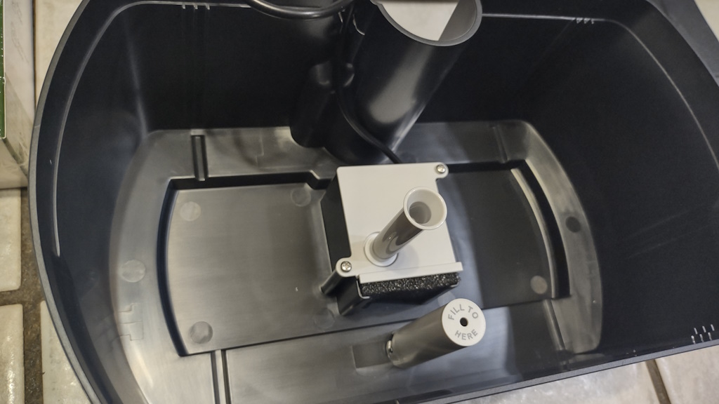 Close-up of the AeroGarden Harvest tub, with the water pump and water level sensor visible