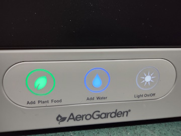 Close-up view of the control buttons on an AeroGarden Harvest