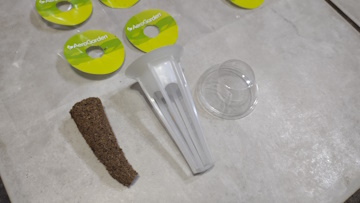 Sample pod, grow plug, cover, and label from the AeroGarden Grow Anything Kit