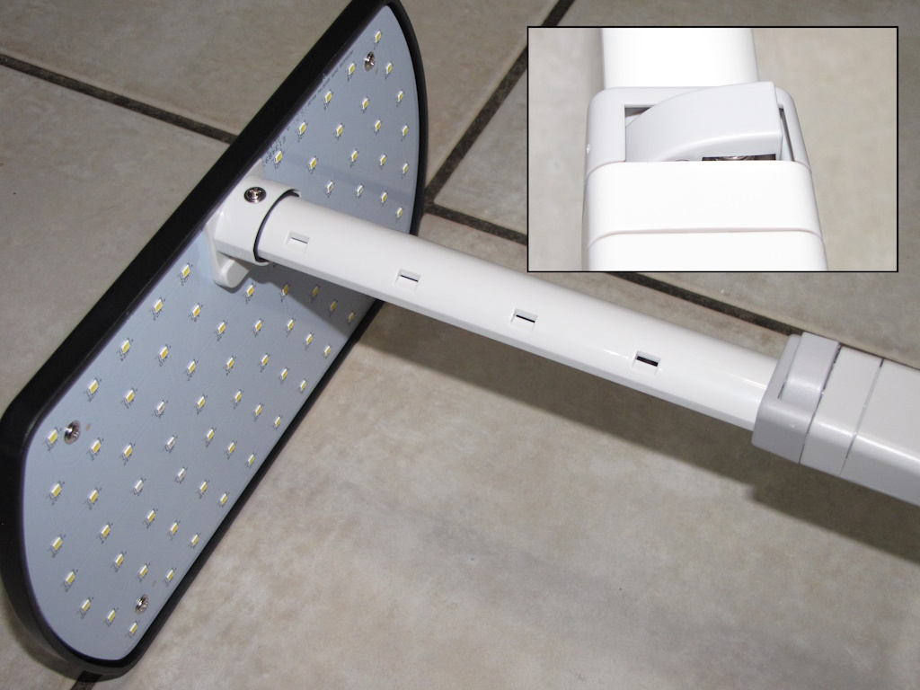 Close-up of the AeroGarden Harvest light assembly with an insert showing a zoomed in view of the button used to adjust light assembly height